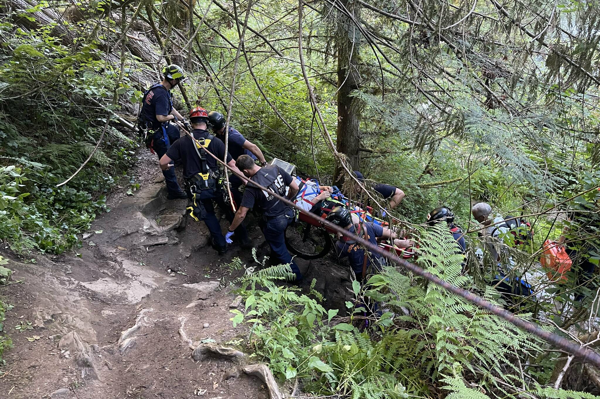 First responders had to wheel an injured swimmer up 300 feet from the Green River bank to a trail on Sunday. Photo courtesy Puget Sound Fire