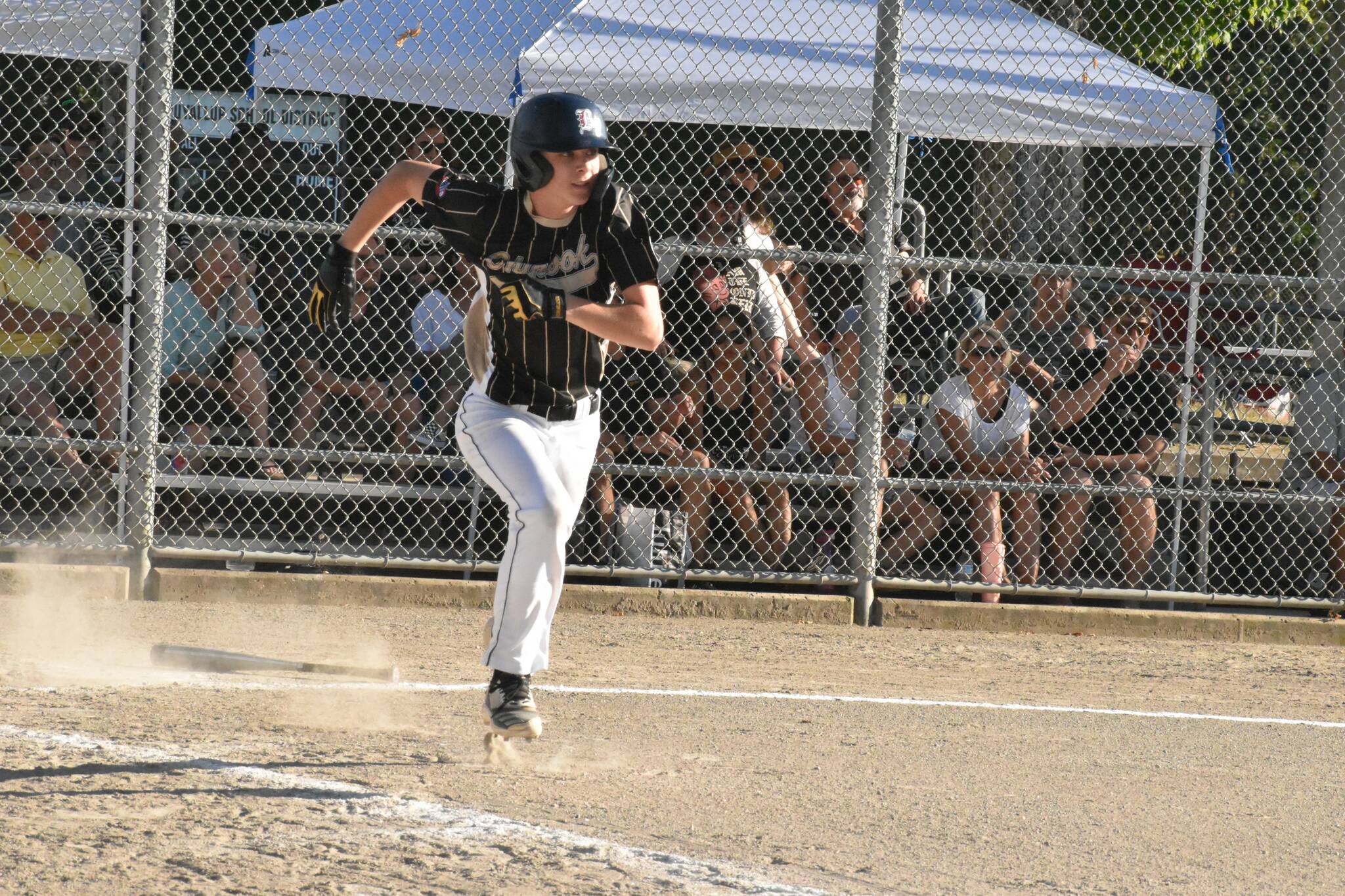 Luke Hanson racing safely to first base during a July 5 game. Photo by Kevin Hanson