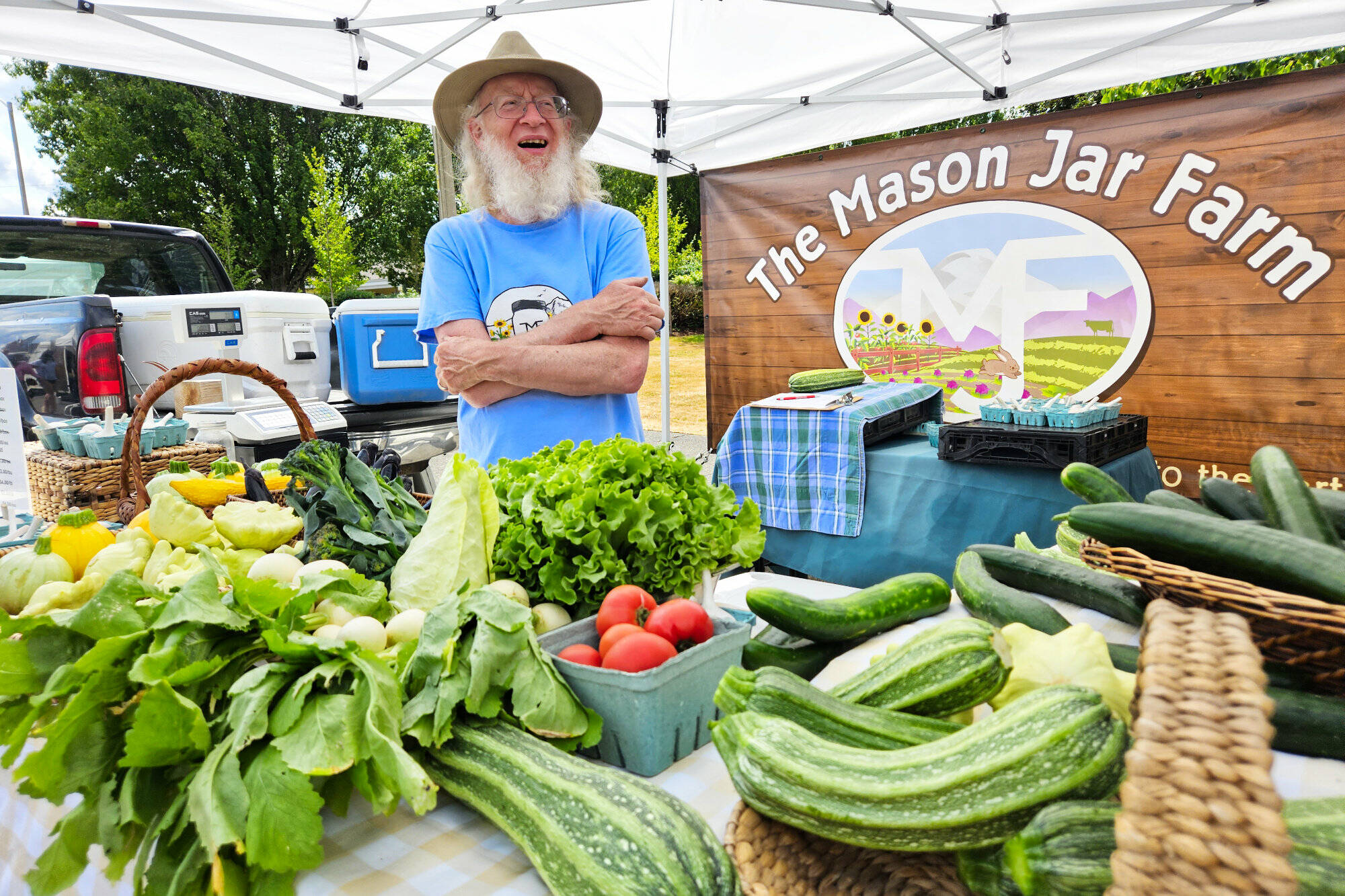 Photo by Ray Miller-Still
The Mason Jar Farm is just one of many local fresh produce vendors selling their wares at the Enumclaw Plateau Farmers Market; pictured at the booth is Farmer Steve.