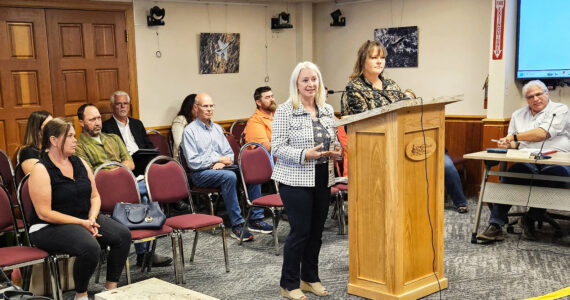 Photo by Ray Miller-Still
Krista Swain and Somer Johnson at the Enumclaw City Council podium during the Aug. 12 meeting. At the bottom left is Jessica, who is a graduate, a year and a half sober, and is now able to visit her children.