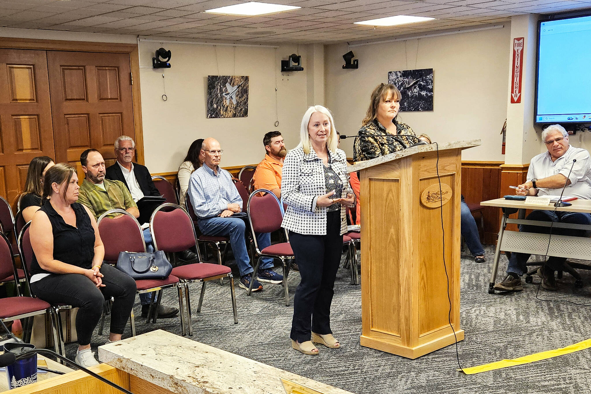 Photo by Ray Miller-Still
Krista Swain and Somer Johnson at the Enumclaw City Council podium during the Aug. 12 meeting. At the bottom left is Jessica, who is a graduate, a year and a half sober, and is now able to visit her children.