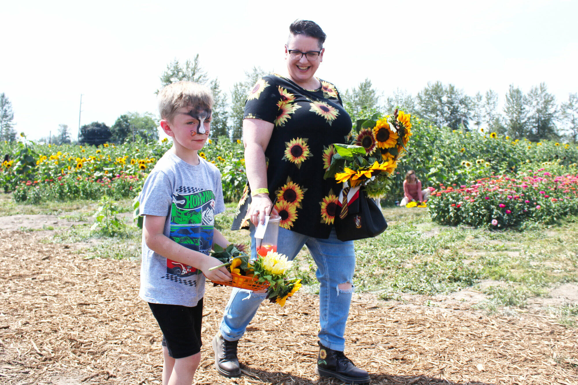 IMaris Farms’ annual Sunflower Days is over for the season — but there’s always next year! The event boasts five acres of sunflowers and zinnias you can walk through, various local arts vendors, and numerous activities for kids and families. Pictured is Easton Williams and Rachel Mead taking flowers to grandma; Charli and Lilah Hetch on the jumping pillow; and Evie Schutt racing some rubber ducks. Photos by Ray Miller-Still