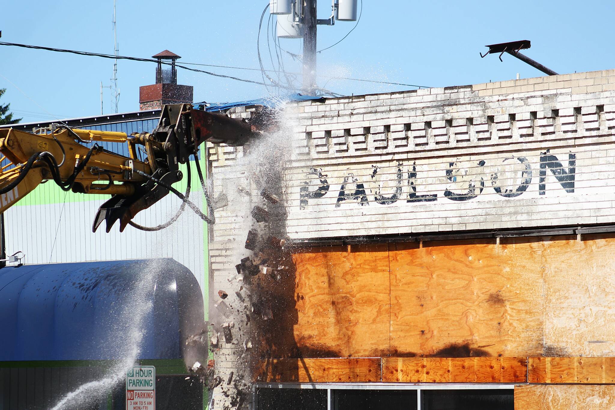 The old Paulson Chevrolet dealership building, which used to be Enumclaw’s first general store, an opera house, Gamblin Motors, and a flooring business over the years, is no longer after demolition crews took down the building on Aug. 28. Photos by Ray Miller-Still