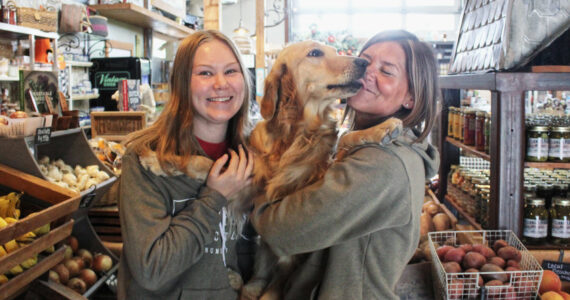 Photo by Ray Miller-Still
Allison and Kerry Holm with Peanut, who works at Sweet Peas every day.