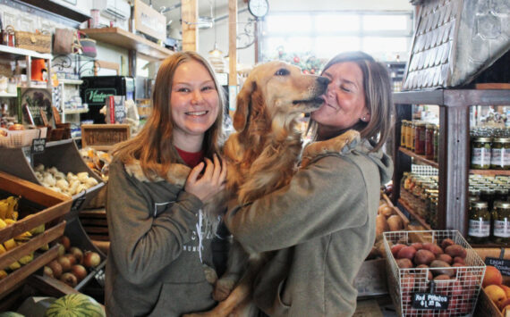 Photo by Ray Miller-Still
Allison and Kerry Holm with Peanut, who works at Sweet Peas every day.