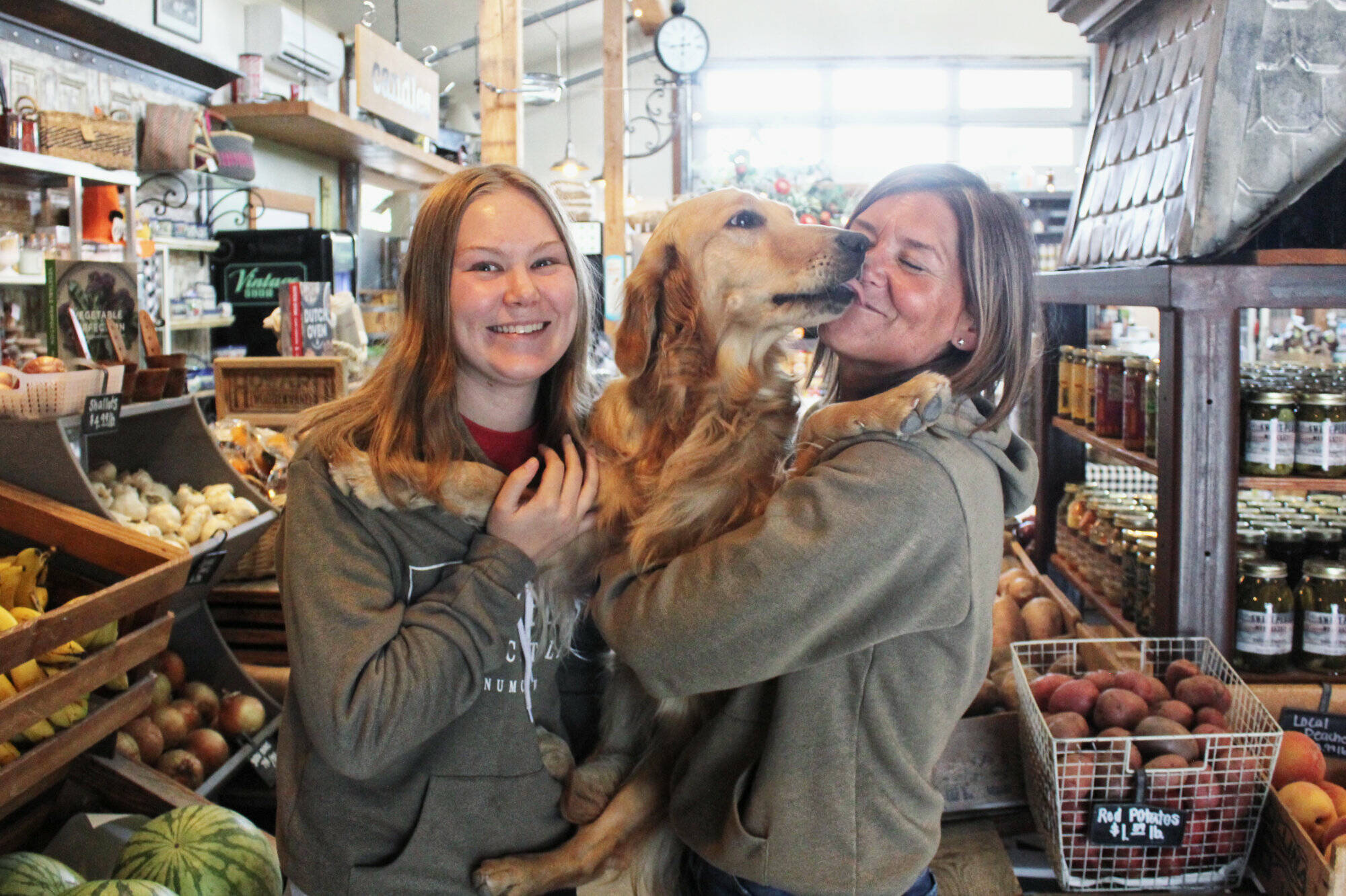 Photo by Ray Miller-Still
Allison and Kerry Holm with Peanut, who works at Sweet Peas every day.