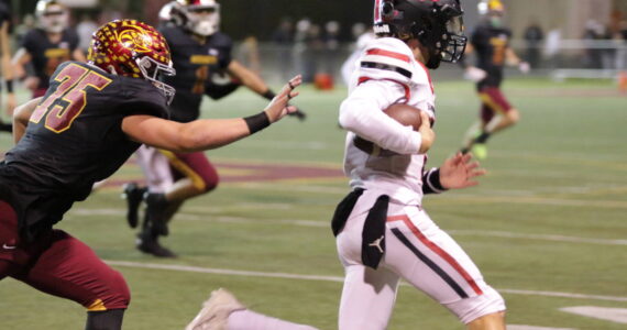 Enumclaw's #75 Ryker Popke continues relentless pursuit be the defense all night against Sammamish. Photo by Todd Overdorf / sonscapeimages.com