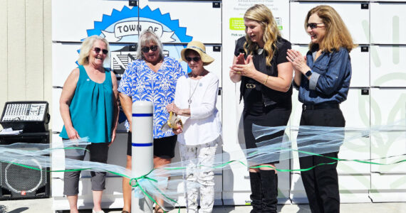 Photo by Ray Miller-Still
Cutting the ribbon for Carbonado’s new refrigerated food locker is Roberta “Doodie” Kyllonen, 90, who is the city’s longest volunteer at the year-old food pantry. Also pictured, left to right, is Shelly Wright and Denise Vesey, co-founders of the food pantry, GoodRoots CEO Stacey Crnich, and Congressional Rep. Dr. Kim Schrier.