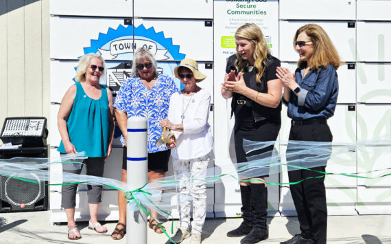 Photo by Ray Miller-Still
Cutting the ribbon for Carbonado’s new refrigerated food locker is Roberta “Doodie” Kyllonen, 90, who is the city’s longest volunteer at the year-old food pantry. Also pictured, left to right, is Shelly Wright and Denise Vesey, co-founders of the food pantry, GoodRoots CEO Stacey Crnich, and Congressional Rep. Dr. Kim Schrier.