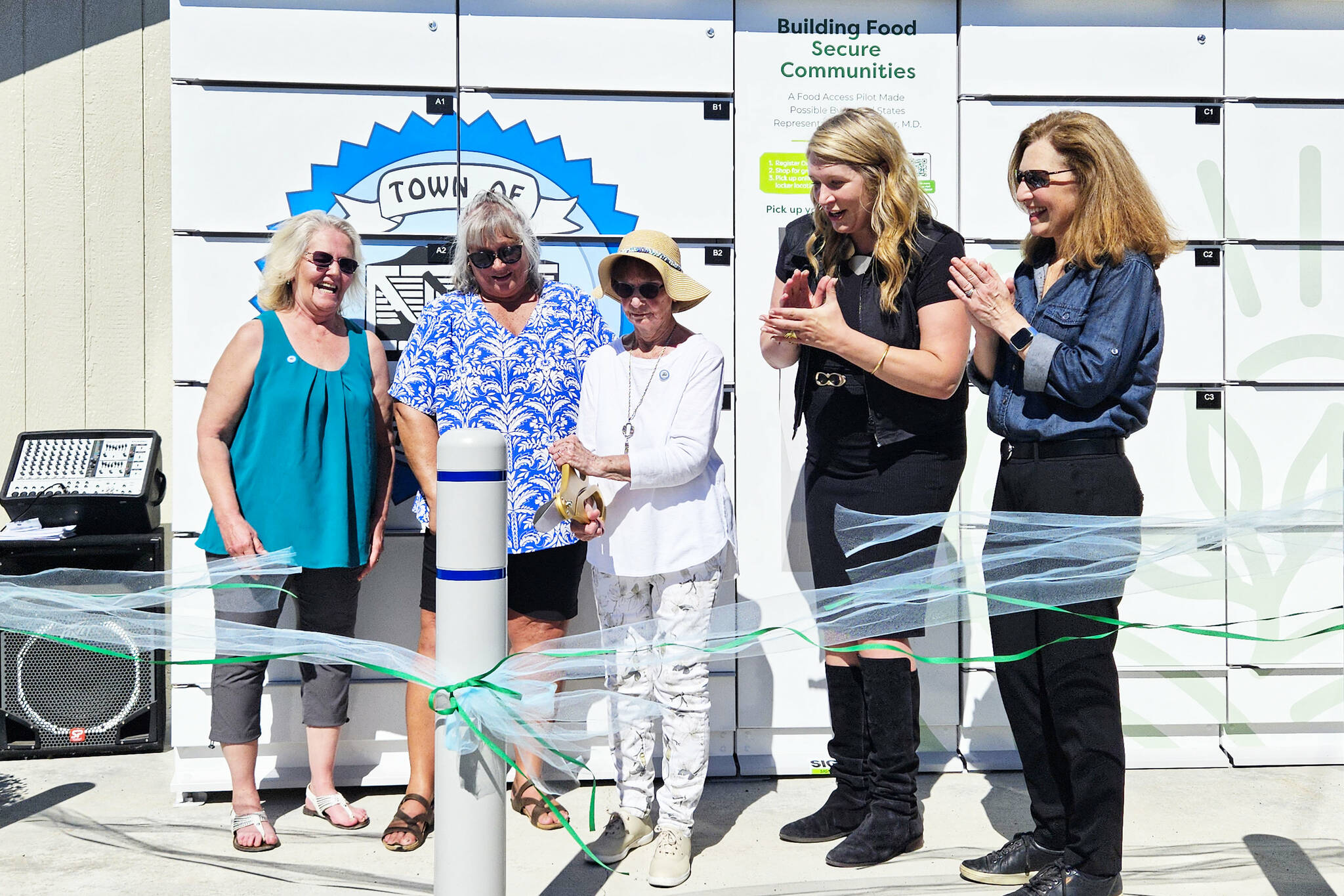 Photo by Ray Miller-Still
Cutting the ribbon for Carbonado’s new refrigerated food locker is Roberta “Doodie” Kyllonen, 90, who is the city’s longest volunteer at the year-old food pantry. Also pictured, left to right, is Shelly Wright and Denise Vesey, co-founders of the food pantry, GoodRoots CEO Stacey Crnich, and Congressional Rep. Dr. Kim Schrier.