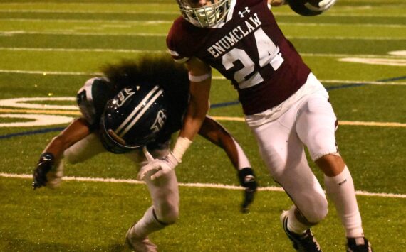 PHOTO BY KEVIN HANSON
Senior Louis Chevalier was among the many Hornet stars Friday night when Enumclaw High crushed the visiting Todd Beamer squad. Here, he evades a would-be Titan tackler during a second-half dash.