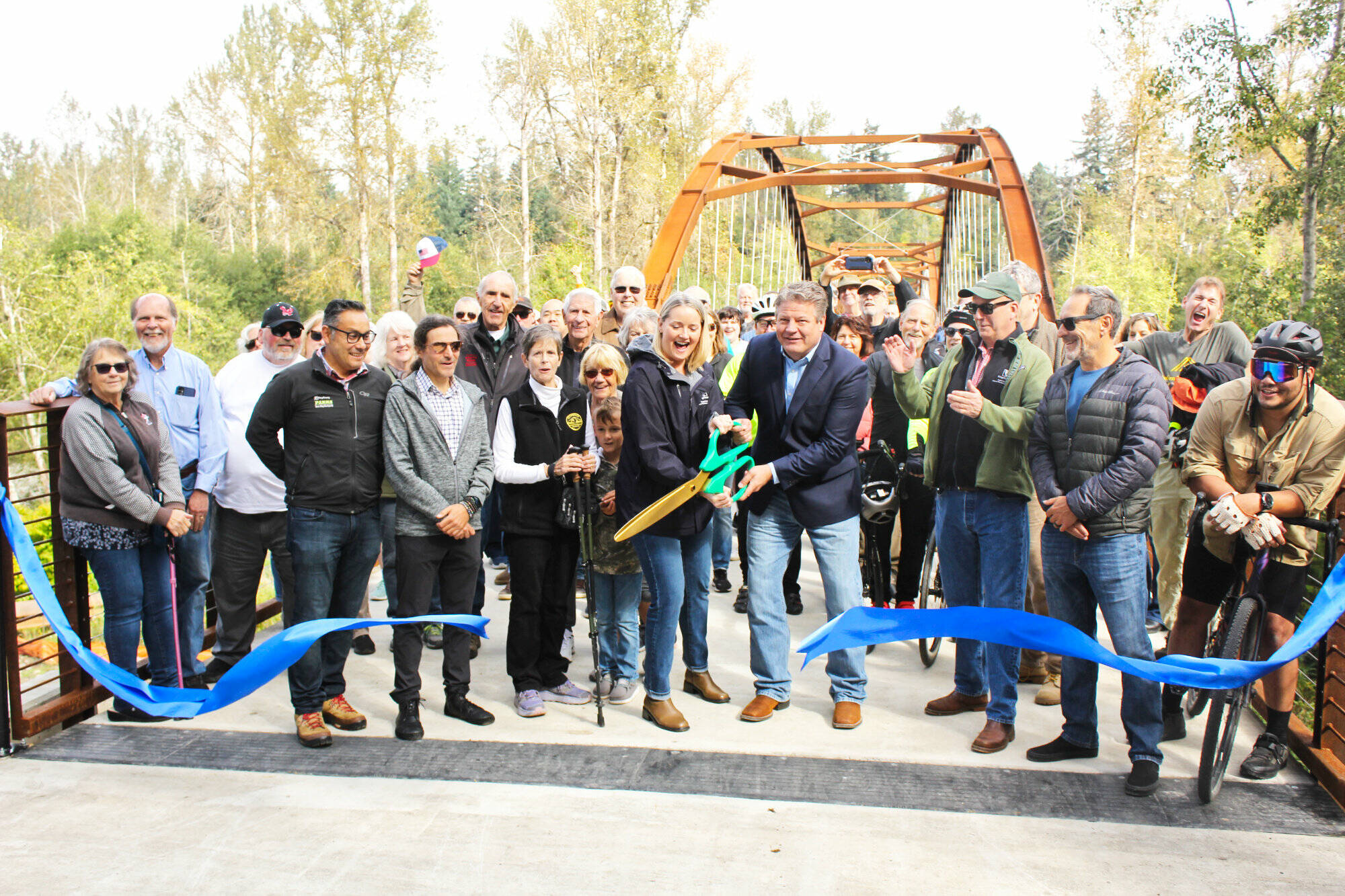 The crowd at the Foothills Trail bridge grand opening last Saturday found themselves practically shoulder to shoulder as they gathered on the new structure for the ribbon cutting. The bridge now connects pedestrians from Enumclaw and Buckley, and doubles as an emergency route for first responders of the traffic bridge fails. Photo by Ray Miller-Still