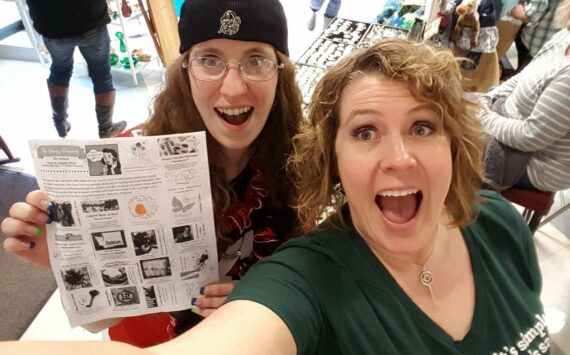 Alisa Garate (right) with a shopper showing off the Hungry Housewives vendor brochure during the 2016 event. This year’s craft show features more than 100 vendors. Photo courtesy Alisa Garate