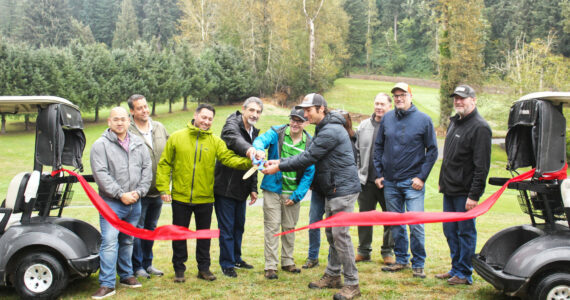 Numerous representatives of various municipal and county governments, plus officials of various county and state departments, gathered on the Enumclaw Golf Course on Oct. 8 to officially cut the ribbon on a Boise Creek re-route project. Included is Enumclaw Councilmember Tom Sauvageau (second from the left) and Enumclaw Mayor Jan Molinaro (fourth from the left).