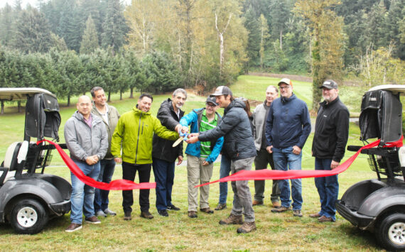 Numerous representatives of various municipal and county governments, plus officials of various county and state departments, gathered on the Enumclaw Golf Course on Oct. 8 to officially cut the ribbon on a Boise Creek re-route project. Included is Enumclaw Councilmember Tom Sauvageau (second from the left) and Enumclaw Mayor Jan Molinaro (fourth from the left).