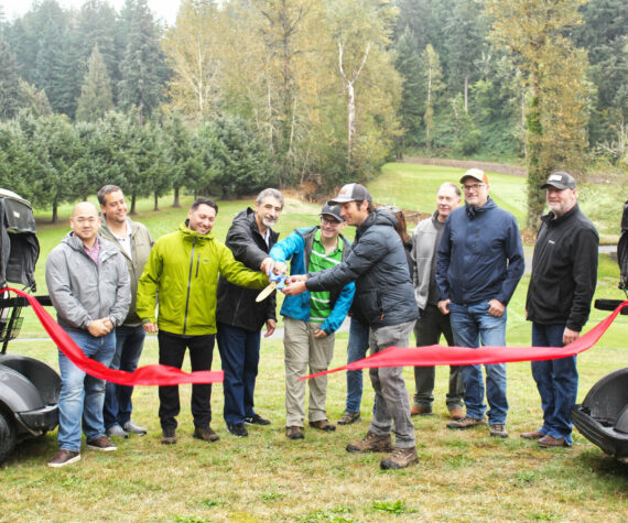 Numerous representatives of various municipal and county governments, plus officials of various county and state departments, gathered on the Enumclaw Golf Course on Oct. 8 to officially cut the ribbon on a Boise Creek re-route project. Included is Enumclaw Councilmember Tom Sauvageau (second from the left) and Enumclaw Mayor Jan Molinaro (fourth from the left).