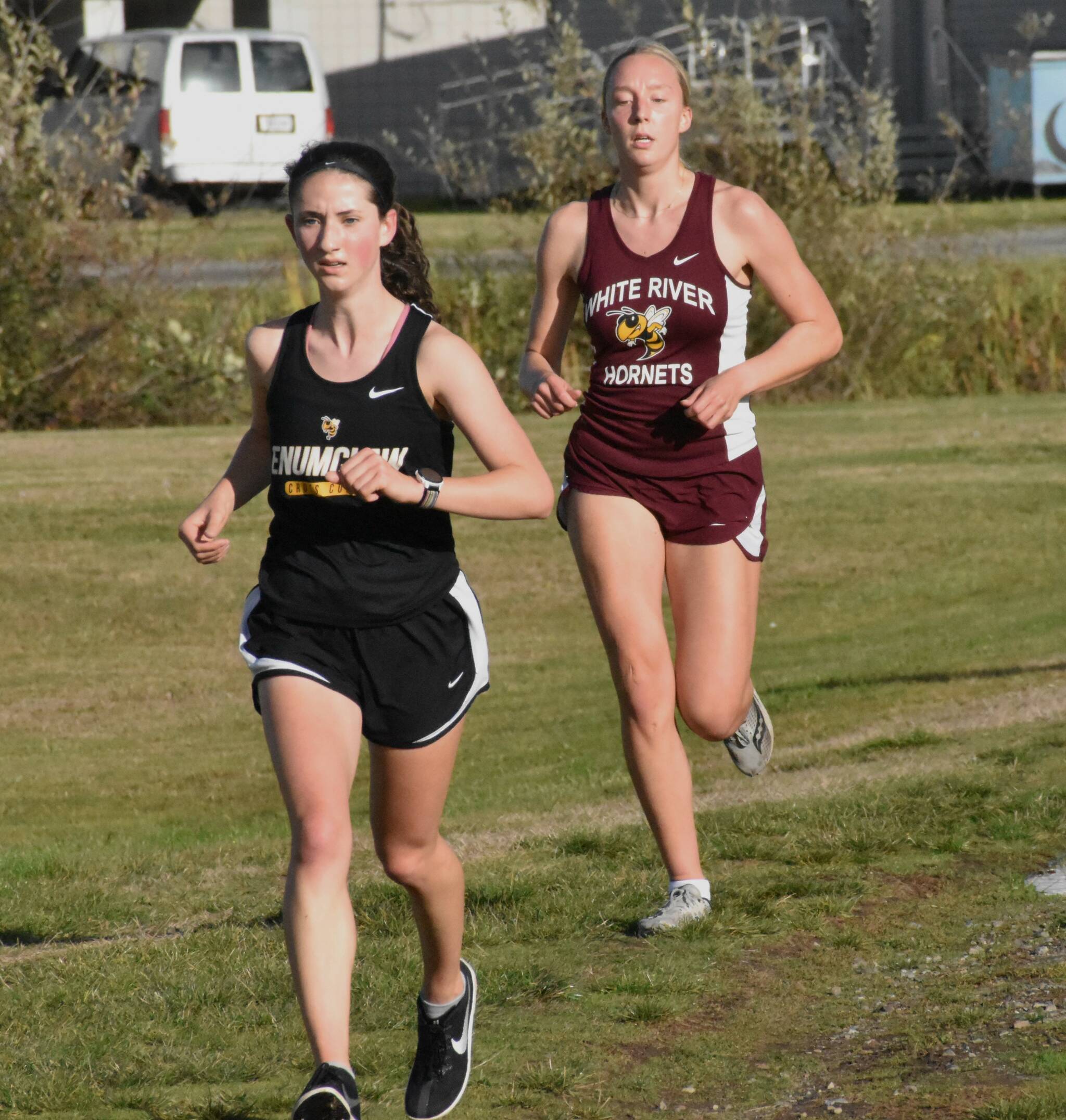 PHOTO BY KEVIN HANSON Enumclaw and White River squared off in cross country action last week, running the 5K course in Enumclaw. Pictured here are Enumclaw’s Lillian Haas and White River’s Vivian Kingston who placed second and third, respectively, in the girls race. Full details from the 3A NPSL meet can be found in Sports Roundup.