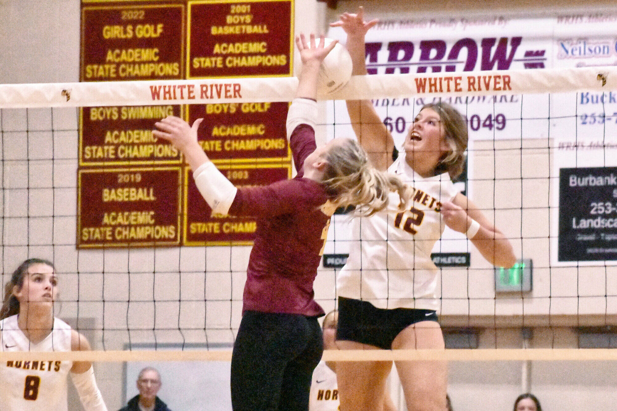 White River and Enumclaw met for the second time this season on the volleyball court and, for the second time, it was the Buckley squad celebrating a straight-set victory. With the Oct. 24 win, White River stayed perfect in league play (14-0) while Enumclaw remained a step back (11-2) in the 3A North Puget Sound League standings. In this photos WR standout Kianna Rohner (#12 in white) battles for a kill at the net. Photo by Kevin Hanson