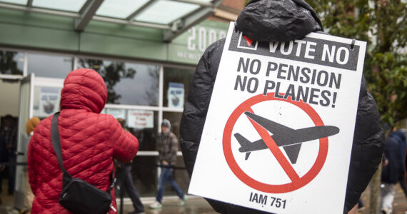 Larry Best, a customer coordinator for quality assurance who has worked at Boeing for 38 years, stands outside of Angel of the Winds Arena with a “vote no” sign on Monday in Everett. (Olivia Vanni / The Herald)