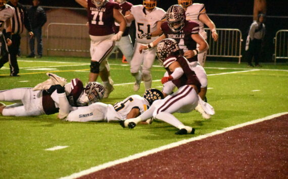 PHOTO BY KEVIN HANSON 
Pictured is a key play in Enumclaw’s Friday night whitewashing of the visiting Southridge Suns. The only time the Suns moved close to the end zone, the Hornets’ Cooper Rodarte wrapped up the legs of the Southridge ballcarrier on fourth down, giving EHS the ball.