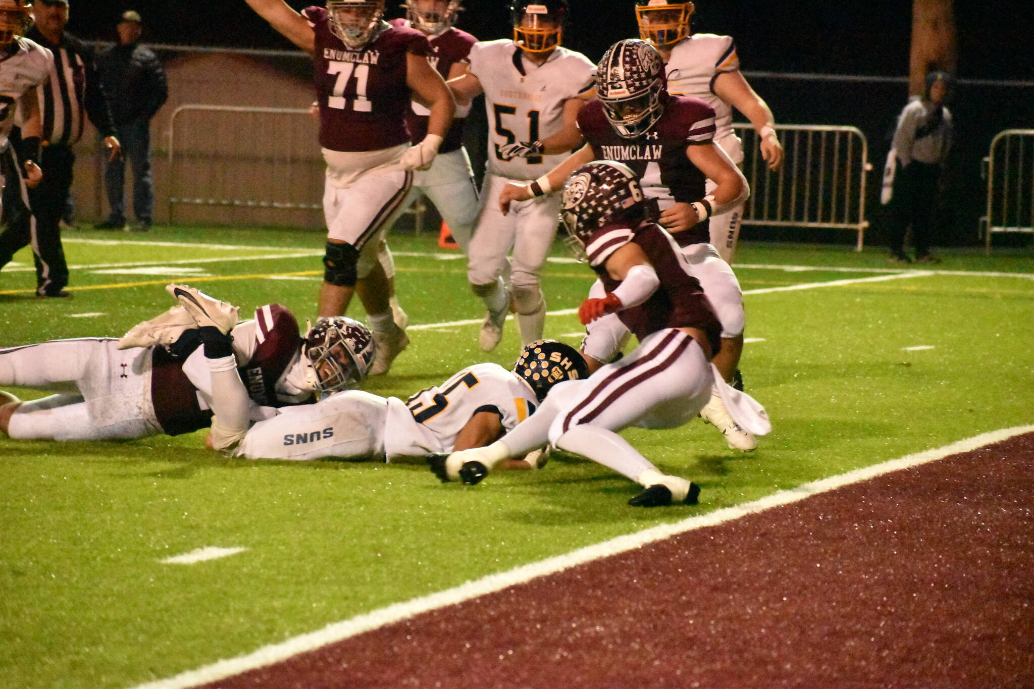 PHOTO BY KEVIN HANSON Pictured is a key play in Enumclaw’s Friday night whitewashing of the visiting Southridge Suns. The only time the Suns moved close to the end zone, the Hornets’ Cooper Rodarte wrapped up the legs of the Southridge ballcarrier on fourth down, giving EHS the ball.