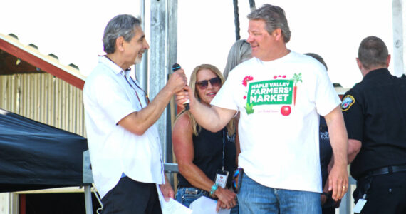 Photo by Ray Miller-Still
King County Councilmember Reagan Dunn often visits Enumclaw for large events like the King County Fair. Here he is receiving the mic from Enumclaw Mayor Jan Molinaro at the fair’s opening ceremony.