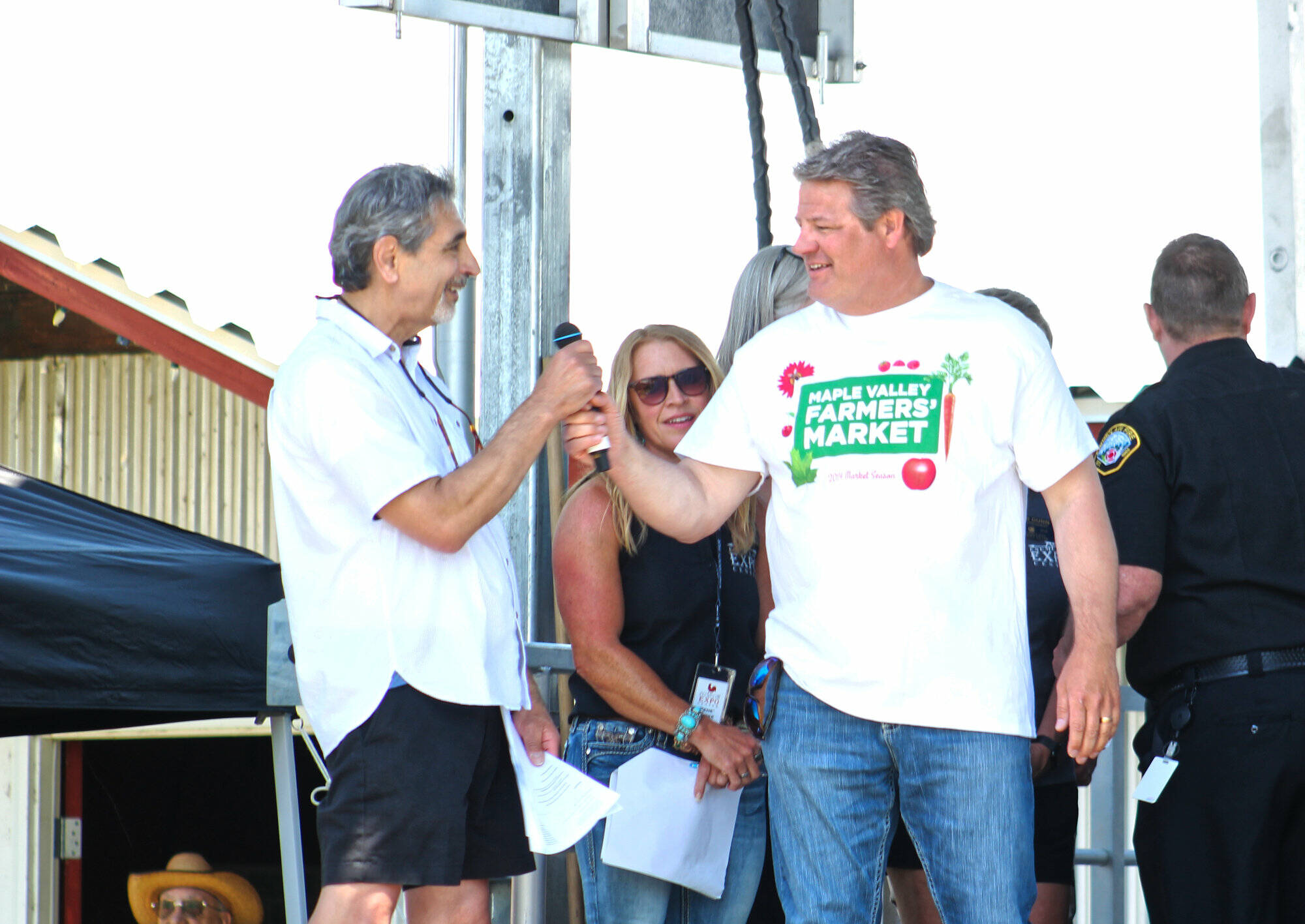 Photo by Ray Miller-Still
King County Councilmember Reagan Dunn often visits Enumclaw for large events like the King County Fair. Here he is receiving the mic from Enumclaw Mayor Jan Molinaro at the fair’s opening ceremony.