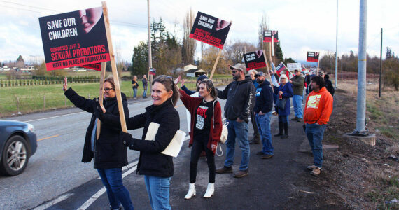 About a hundred people gathered in SR 164 outside Garden House, a group home for high-level sex offenders on Feb. 17, 2023, to protest and gain support to pressure the state to move sole resident Stevan Knapp, including Cathy Dahlquist (at front). Photo by Ray Miller-Still