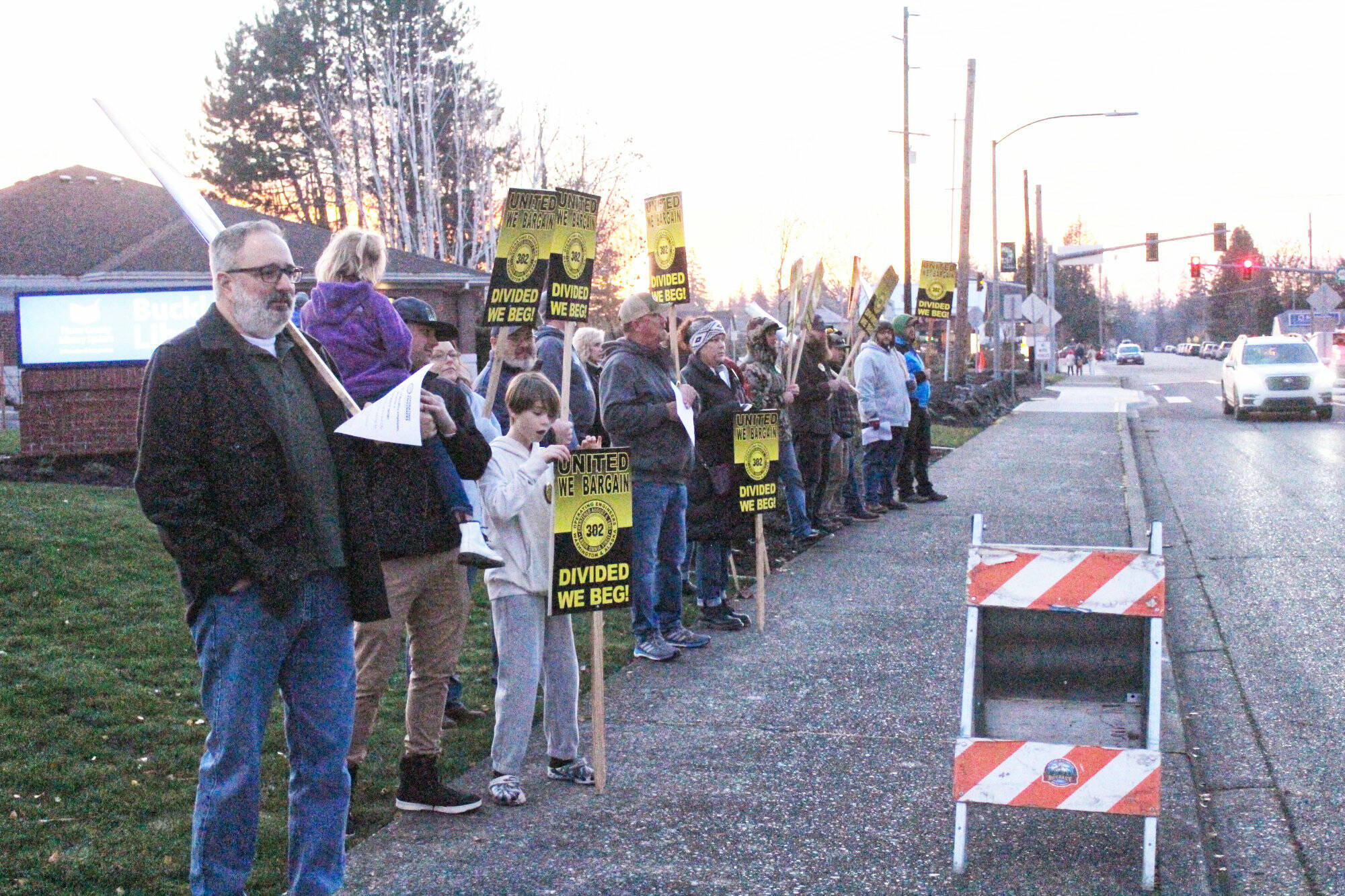 About a dozen people lined up on Main Street across the Buckley tree lighting event festivities to support a new contract with the city. Photo by Ray Miller-Still