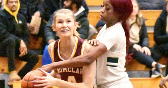 PHOTO BY KEVIN HANSON
Making her way to the basket, despite a serious foul by a Todd Beamer player, is Enumclaw High’s Isabella Pohlman.