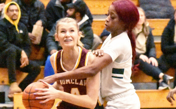 PHOTO BY KEVIN HANSON
Making her way to the basket, despite a serious foul by a Todd Beamer player, is Enumclaw High’s Isabella Pohlman.