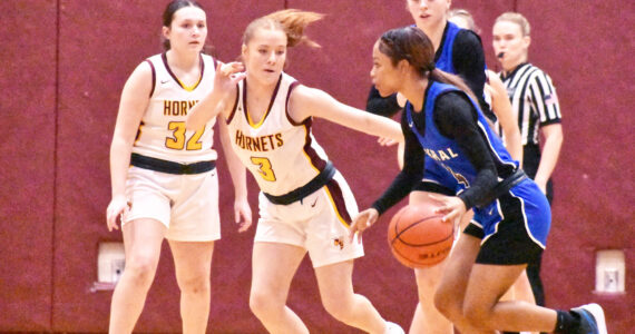 PHOTO BY KEVIN HANSON Malia Froemke (#3) is playing defense in this photo but it was all about her offense during the season’s first Battle of the Bridge on Jan. 8. She tied a school record with 10 3-pointers during her team’s defeat of Enumclaw.