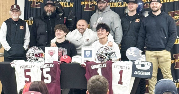 Contributed photo 
Enumclaw High football players were joined by Hornet head coach Mark Gunderson during last week’s signing ceremony at the school. They are joined by assistant coaches Greg Naegle, Scott Eilertson, Coronel Smith, Gil Russell, Colby Thompson and Loren Standiford.