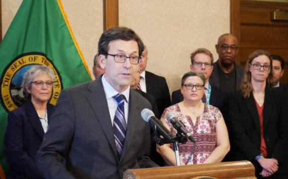 Gov. Bob Ferguson speaks to reporters at the state Capitol on Feb. 27 in Olympia about his plans to cut state spending by about $4 billion over four years. (Photo by Bill Lucia/Washington State Standard)